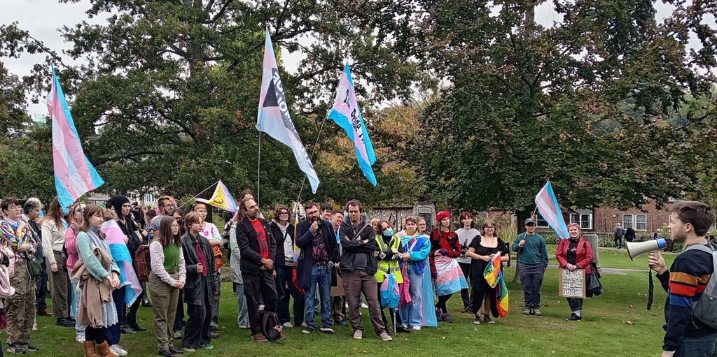 a poster that reads: "We are proud to present... Trans Pride Winchester, Saturday the 13th of July 2024. There is a photo of a "trans rights are human rights" sign.